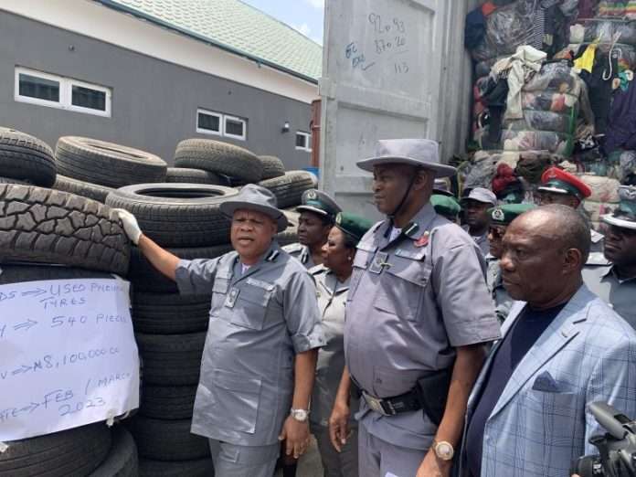 Ag Comptroller Federal Operations Unit ZoneC of the Nigeria Customs Service Mr Kayode Kolade a Deputy Comptroller of Customs DC displaying contraband seized by the Zone in Owerri on Wednesday